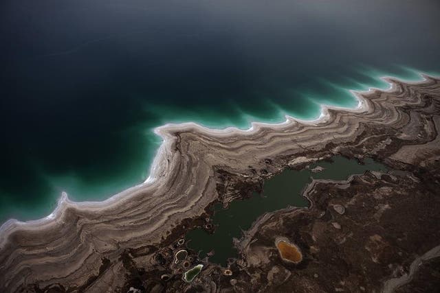 The Dead Sea: This aerial view photo shows sinkholes created by the drying of the Dead Sea, near Kibbutz Ein Gedi
