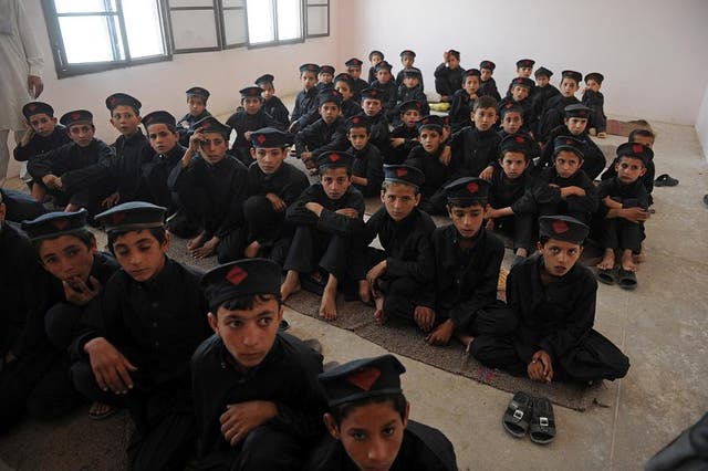 Pakistani boys attend a class at a school in the mountainous area of the Jhanda tribal district of Mohmand Hills 
