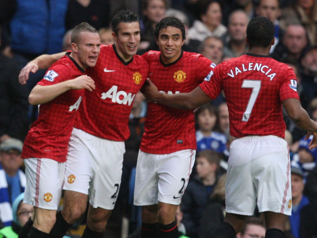 Robin van Persie of Manchester United (2nd L) celebrates scoring their second goal