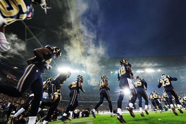 St.Louis Rams run out on the field prior to the NFL International Series match against the New England Patriots