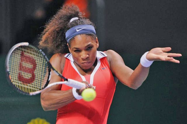 Serena Williams returns a shot to Maria Sharapova during their final tennis match of the WTA Championships in Istanbul