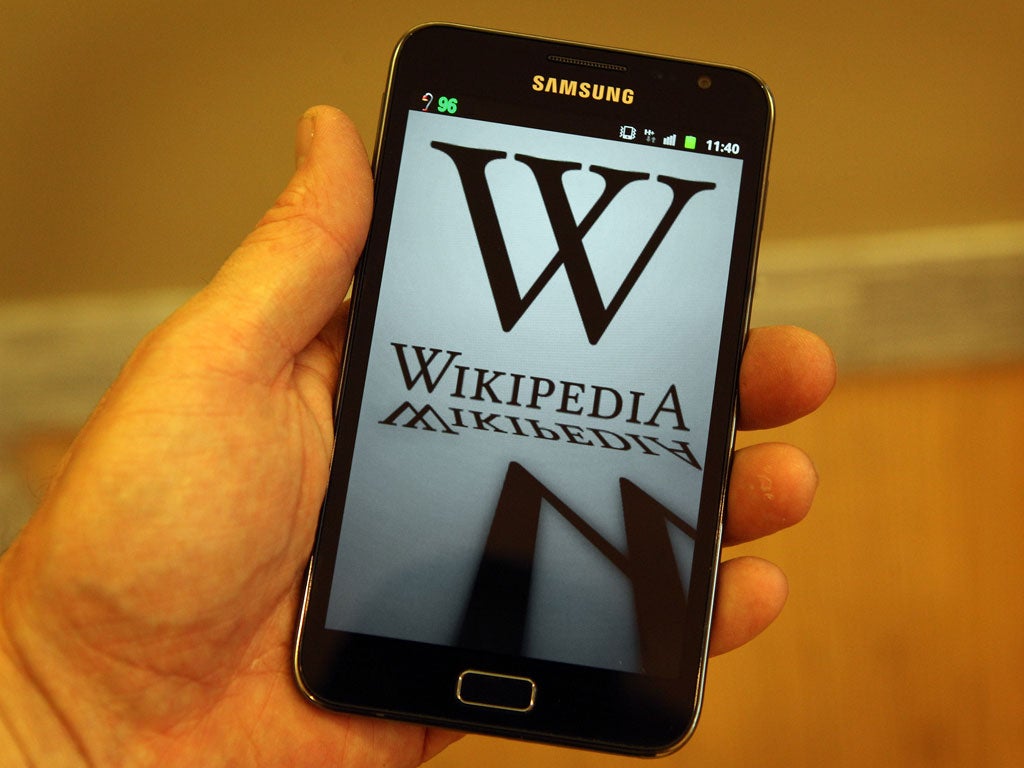 A mobile device shows Wikipedia's front page displaying a darkened logo on January 18, 2012 in London, England.