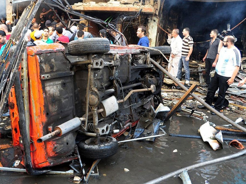 The aftermath of a car bomb in Jaramana, southern Damascus