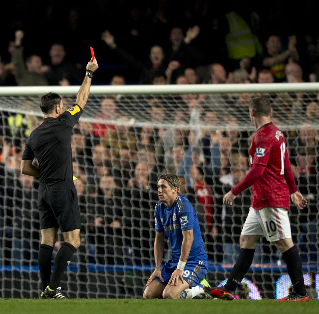 Fernando Torres is shown a red card in the match against Manchester United