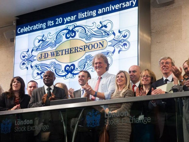 JD Wetherspoon founder Tim Martin (centre) marks his company's 20 years as a listed company today by opening trading on the London Stock Exchange
