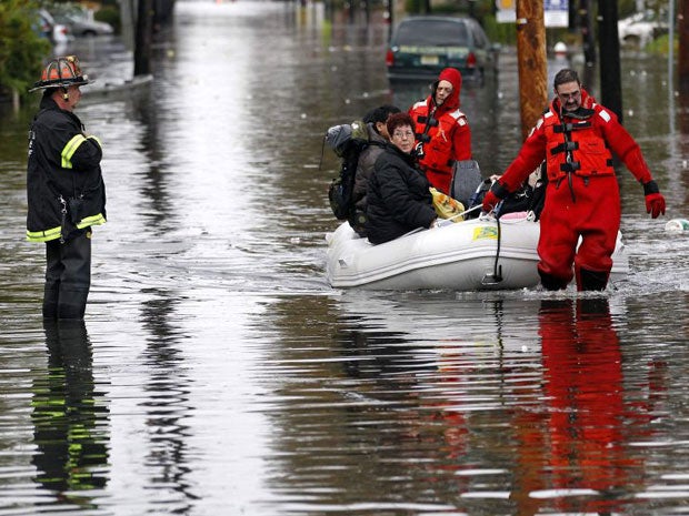 Emergency personnel rescue residents from flood waters brought on by Hurricane Sandy in Little Ferry