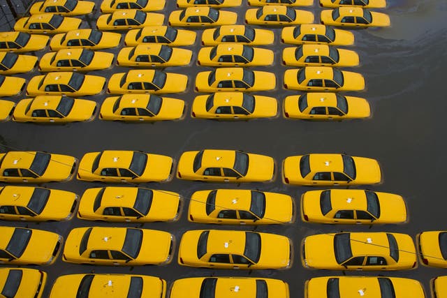 A flooded parking lot full of yellow cabs