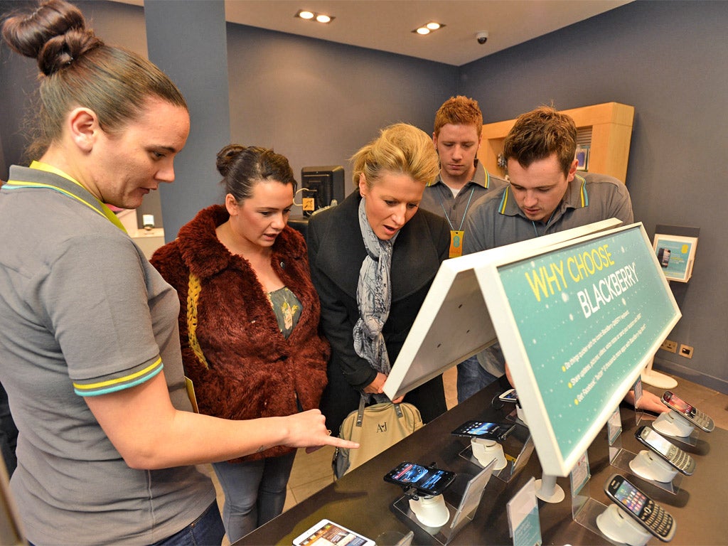 Shoppers at an EE store in Glasgow learn about 4G mobile phones