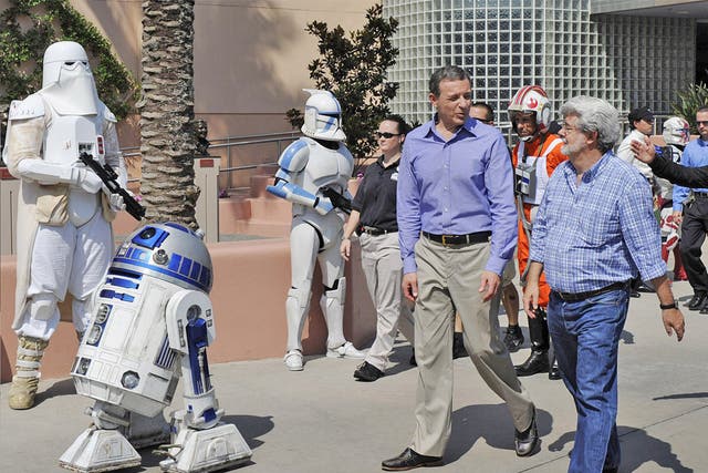 Walt Disney president and CEO Bob Iger with George Lucas, right, in Disney's Hollywood Studios theme park