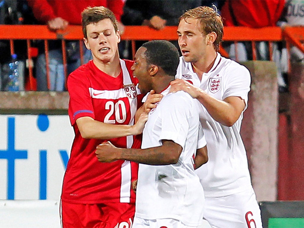 Rose is held back by Craig Dawson and Serbia's Ninkovic