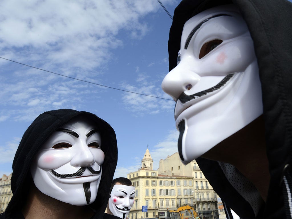 Protesters wearing Guy Fawkes masks take part in a march of the 'Anonymous' movement on October 20, 2012 in Marseille, southern France.