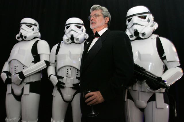 Three more episodes? Star Wars creator George Lucas poses with Storm Troopers in 2005. Disney is planning to make a further three Star Wars films if a buyout of Lucasfilm goes ahead