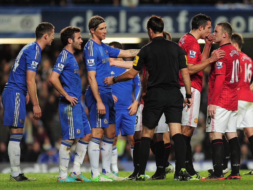 Mark Clattenburg attempts to deal with Chelsea and Manchester United players