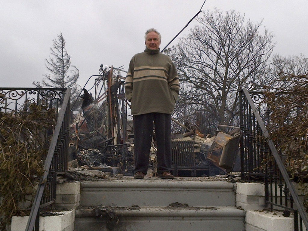 Bruce Bavasso stands in front of what is left of his home in the Belle Harbor neighborhood of New York