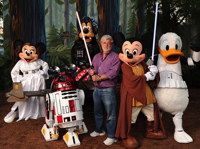 In this handout image provided by Disney, with the stern and determined look of a Jedi Knight, 'Star Wars' creator and filmmaker George Lucas poses with a group of 'Star Wars'-inspired Disney characters Aug. 14, 2010 at Disney's Hollywood Studios theme pa