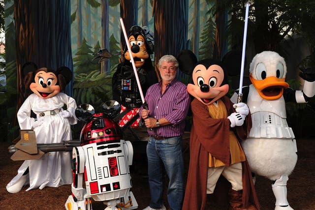 In this handout image provided by Disney, with the stern and determined look of a Jedi Knight, 'Star Wars' creator and filmmaker George Lucas poses with a group of 'Star Wars'-inspired Disney characters Aug. 14, 2010 at Disney's Hollywood Studios theme pa