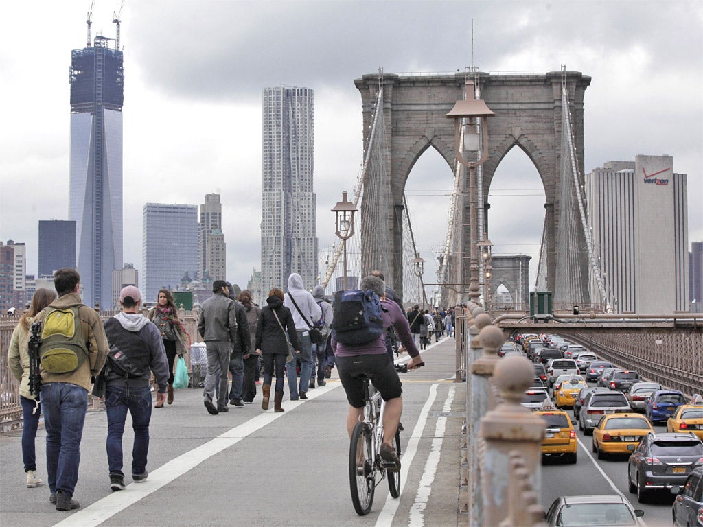 Commuters cross the Brooklyn bridge into Manhattan