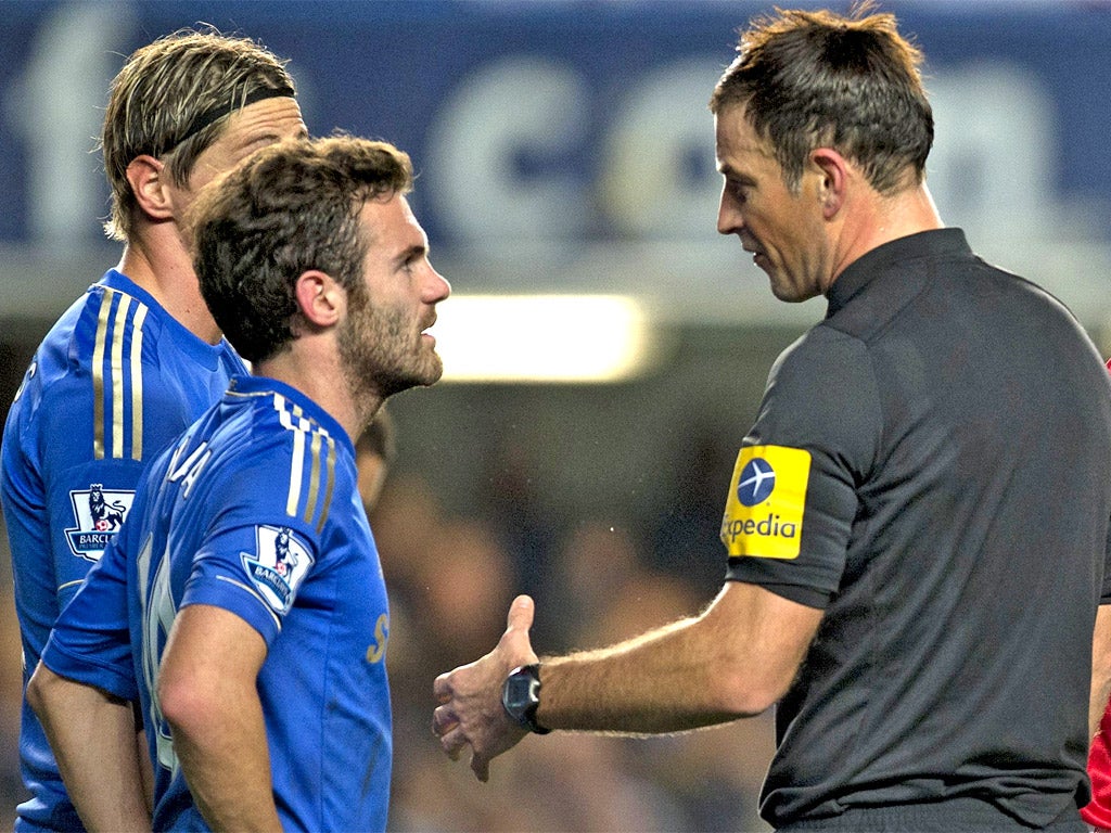 Juan Mata and Mark Clattenburg during an exchange on Sunday