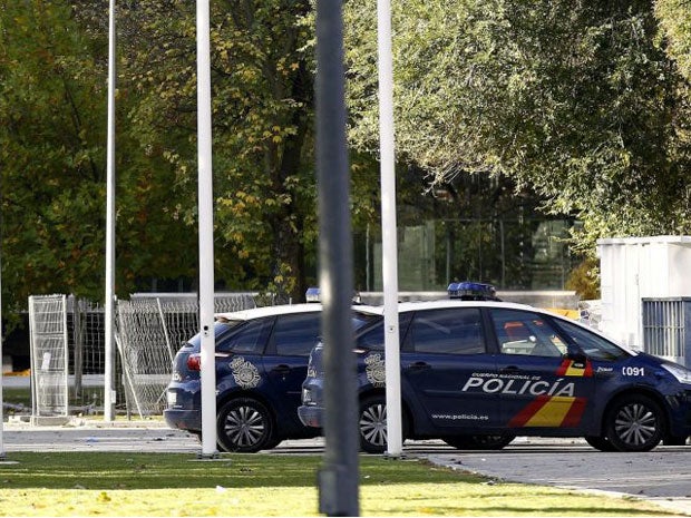 Two police cars are seen parked outside Madrid Arena pavilion where three girls died and two others were seriously injured after they attended a Halloween party