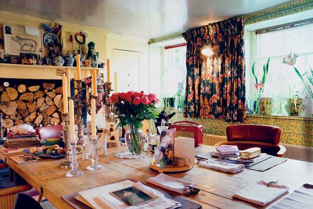 The 1930s chintz tiles lining Vivienne Westwood's basement kitchen were here when she moved in. A black-patterned Ermin print from a Westwood Gold Label show was used to make the curtains. Books and papers are much in evidence, along with a red Roberts radio - Vivienne is a great fan of Radio 4