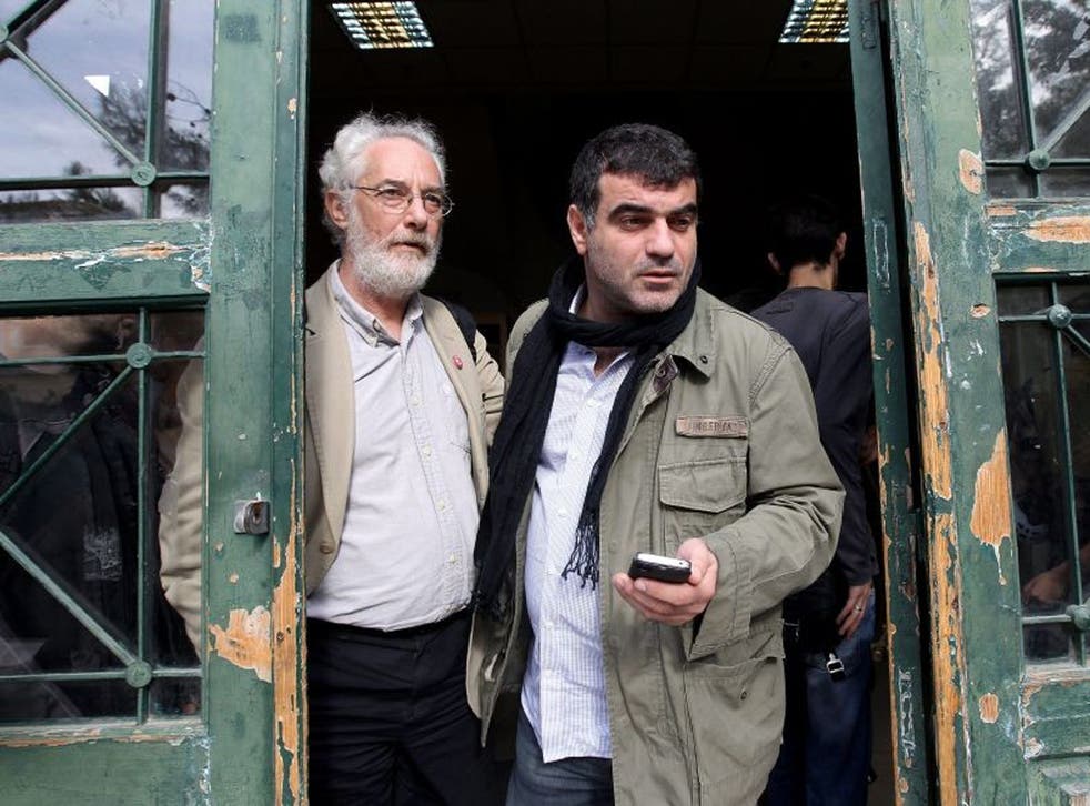 Kostas Vaxevanis, right, outside the court in Athens yesterday; activists hailed the prosecution as a sad day for democracy