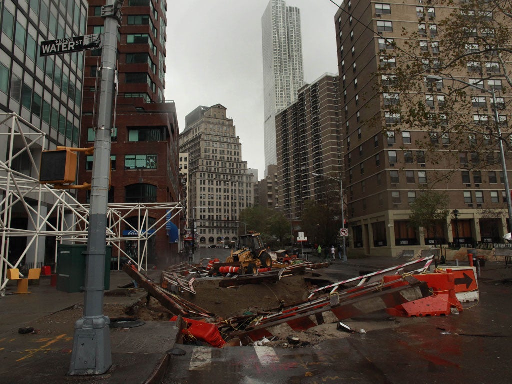 A construction site sinks into a large hole on South Street Seaport following Hurricane Sandy October 30, 2012 in Manhattan, New York.