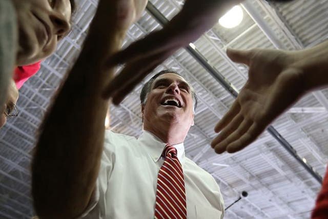 Mitt Romney greets supporters during a campaign event in Virginia