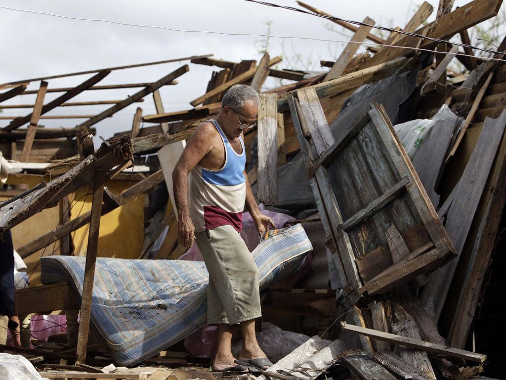 Aguacat, Cuba: Antonio Garces tries to recover belongings from his house destroyed in Aguacat