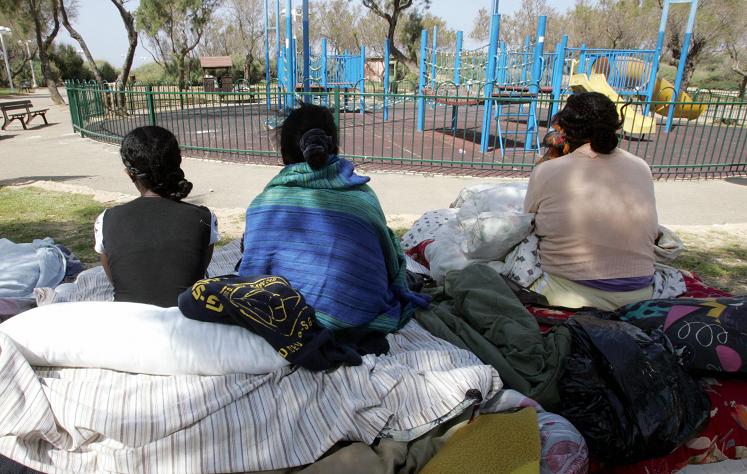 Illegal African immigrants from Ivory Coast and Eritrea gather at a public garden in Tel Aviv