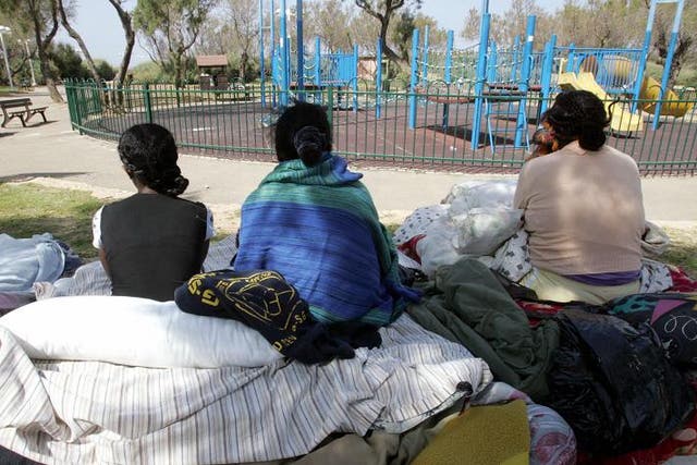 Illegal African immigrants from Ivory Coast and Eritrea gather at a public garden in Tel Aviv