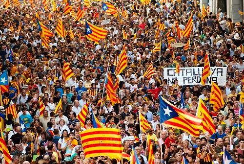 Protesters wave Catalan flags during a protest march