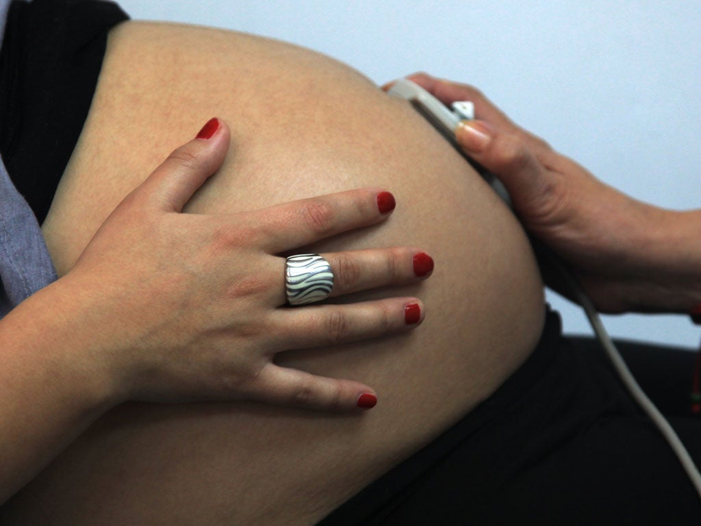 33-week pregnancy, is seen by a midwife in a routine checkup, in Santiago, Chile, on July 13, 2012.