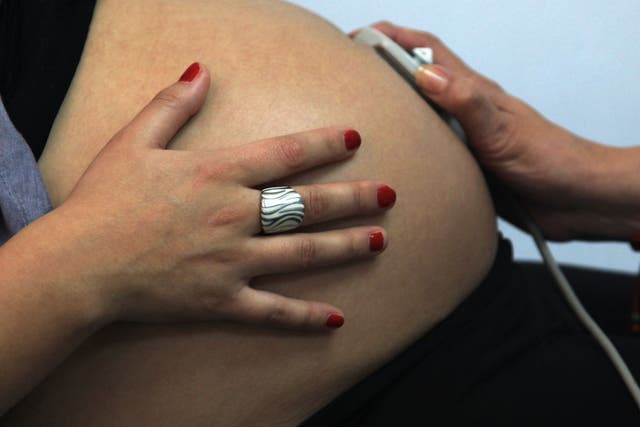 33-week pregnancy, is seen by a midwife in a routine checkup, in Santiago, Chile, on July 13, 2012.
