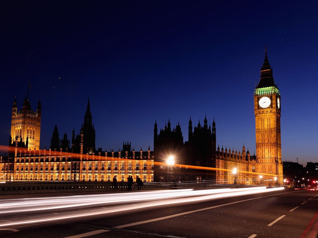 A car travels along Westminster Bridge past the Houses of Parliament on March 27, 2012 in London, England.