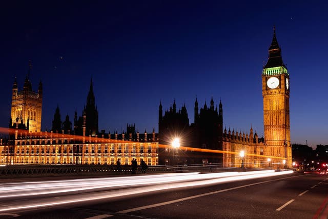 A car travels along Westminster Bridge past the Houses of Parliament on March 27, 2012 in London, England.