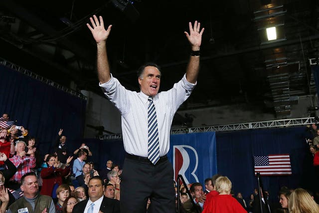 Republican presidential candidate, former Massachusetts Gov. Mitt Romney greets supporters during a campaign rally at the Hy Vee Center in Des Moines, Iowa