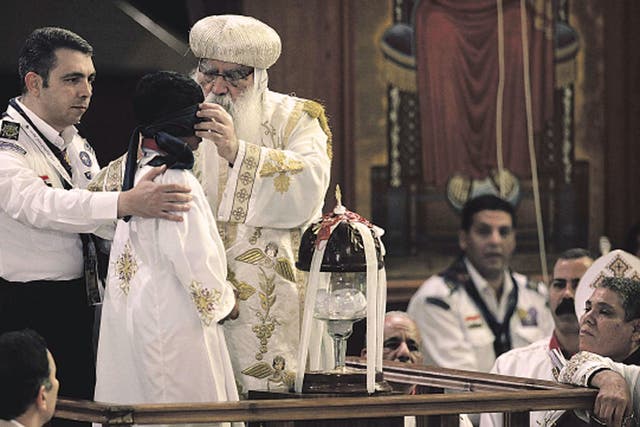 The acting Coptic Pope, Bishop Pachomius, blindfolds Bishoy
Massad, the eight-year-old selected to draw the name of the next patriarch at St Mark’s Cathedral in Cairo