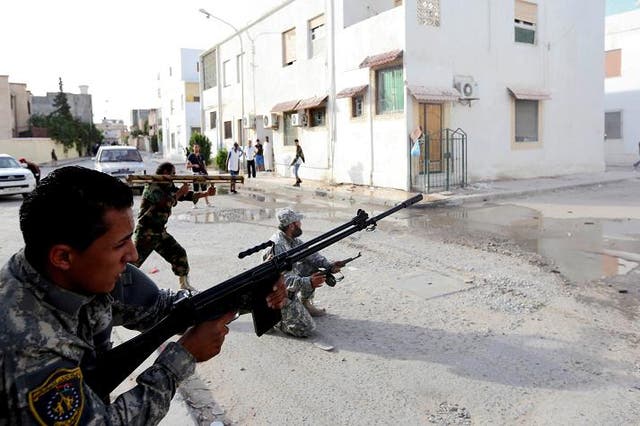 Libyan state security forces known as the National Mobile Forces fire to disband clashes between armed groups near Zawiya street in the Libyan capital, Tripoli