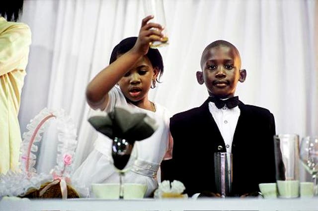 Children toast at a 2005 wedding reception in Soweto