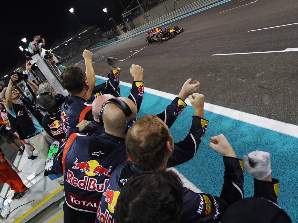 Team mates celebrate as Sebastian Vettel finishes third during the Abu Dhabi Formula One Grand Prix