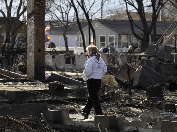 A woman walks through an area impacted by Superstorm Sandy in Breezy Point