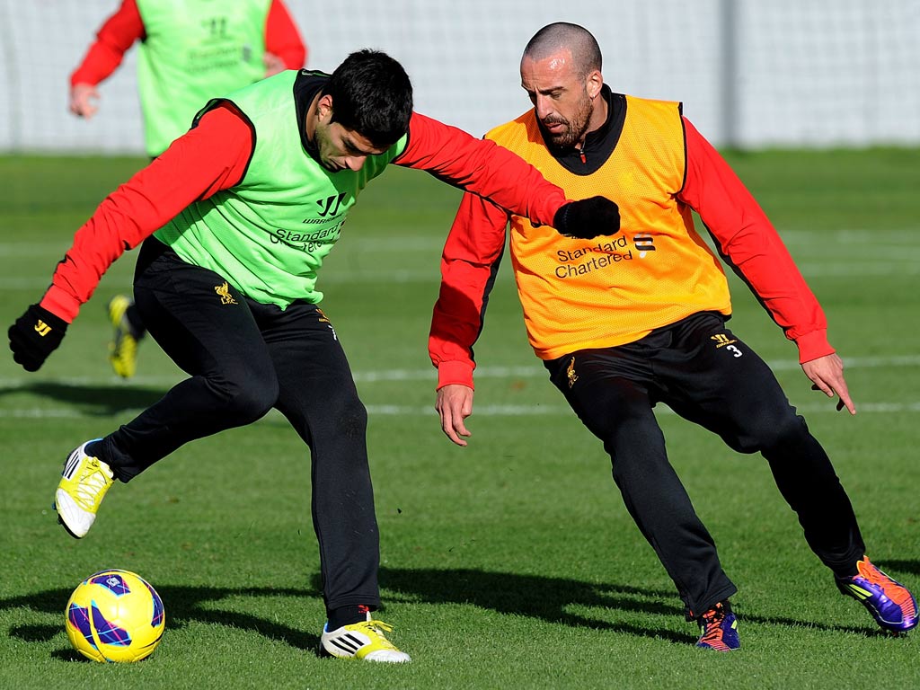 Liverpool defender Jose Enrique trains with Luis Suarez