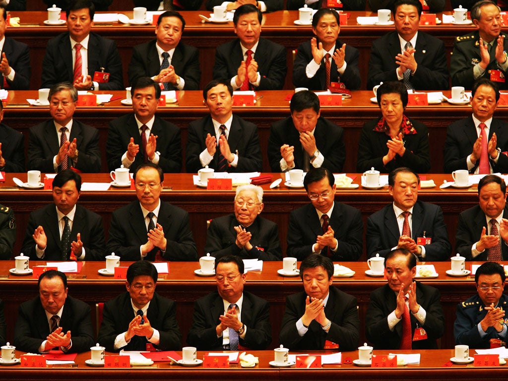 Chinese delegates applaud the result of a vote during the Chinese Communist Party Congress at the Great Hall of the People on October 21, 2007 in Beijing, China.