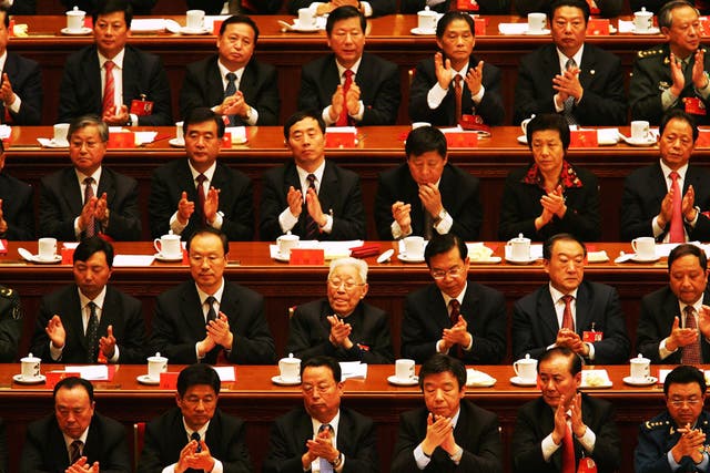 Chinese delegates applaud the result of a vote during the Chinese Communist Party Congress at the Great Hall of the People on October 21, 2007 in Beijing, China.