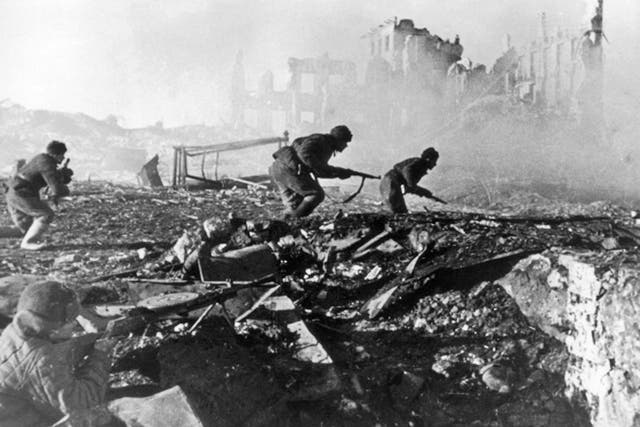 Red Army troops storm a building, and German prisoners, below, during the Battle of Stalingrad