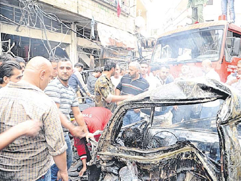 The wreckage from a car bomb in the Mezzeh district of Damascus, in which 11 people died and dozens were wounded