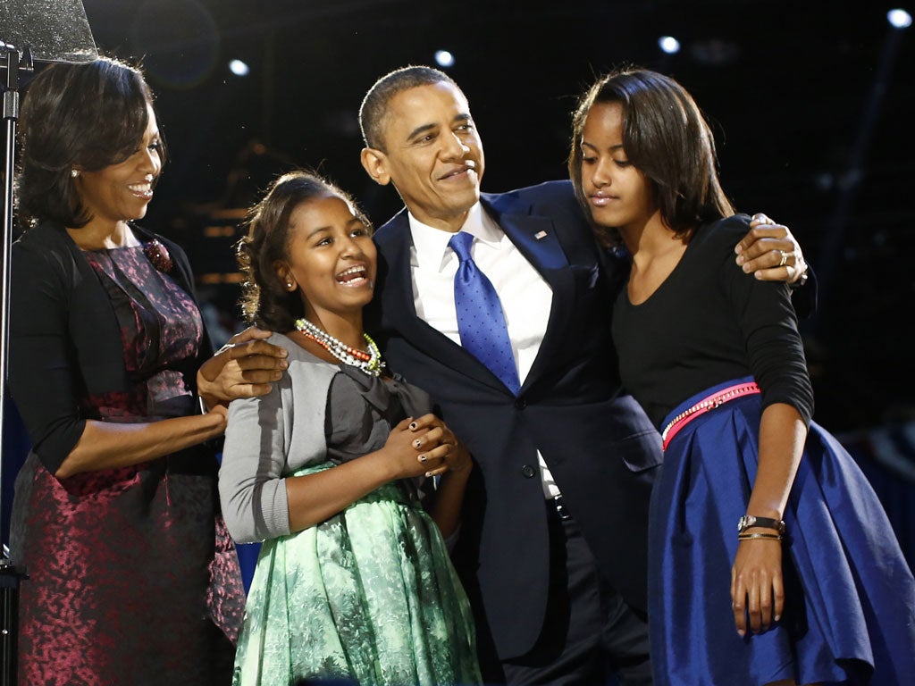 November 7, 2012: U.S. President Barack Obama celebrates with first lady Michelle Obama and their daughters Malia (R) and Sasha at their election night victory rally in Chicago.