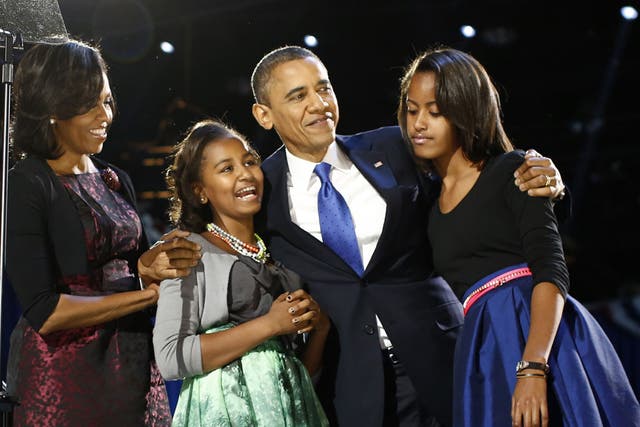 November 7, 2012: U.S. President Barack Obama celebrates with first lady Michelle Obama and their daughters Malia (R) and Sasha at their election night victory rally in Chicago. 