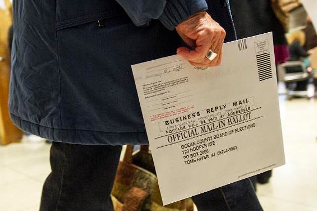 An Ocean County voter in Toms River, New Jersey, carries her completed ballot in an envelope, in a special early mail voting arrangement to allow citizens of the areas affected by Hurricane Sandy to vote in person on short notice in the US national and lo