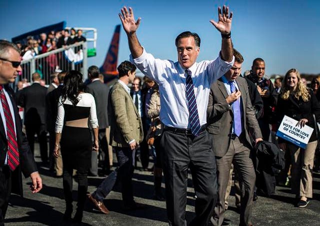 Republican presidential candidate Mitt Romney returns to the campaign plane after a campaign rally in Lynchburg, Virginia. He was also campaigning in Florida, Ohio and New Hampshire on the eve of the election.